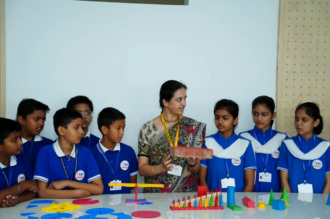 A teacher leading an activity-based lesson with primary students