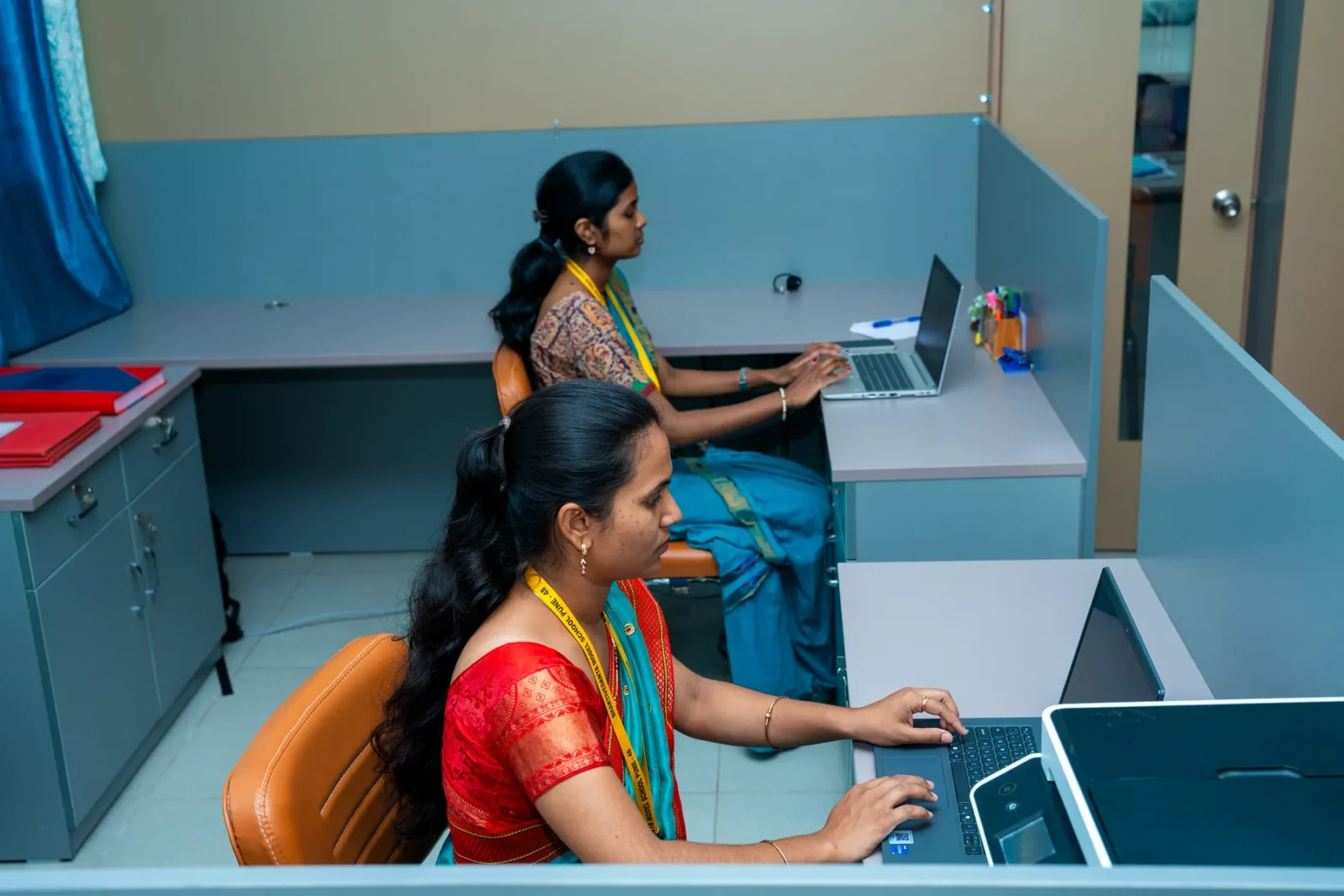Staff at their workstations in the examination room
