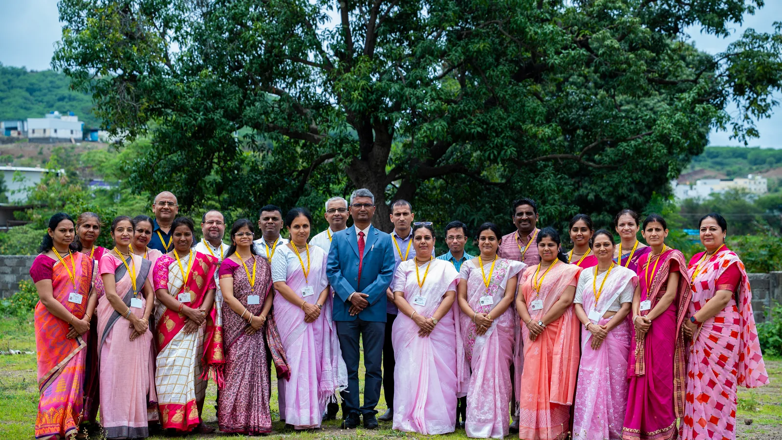 The teaching staff and the chairman, photographed together on the school ground