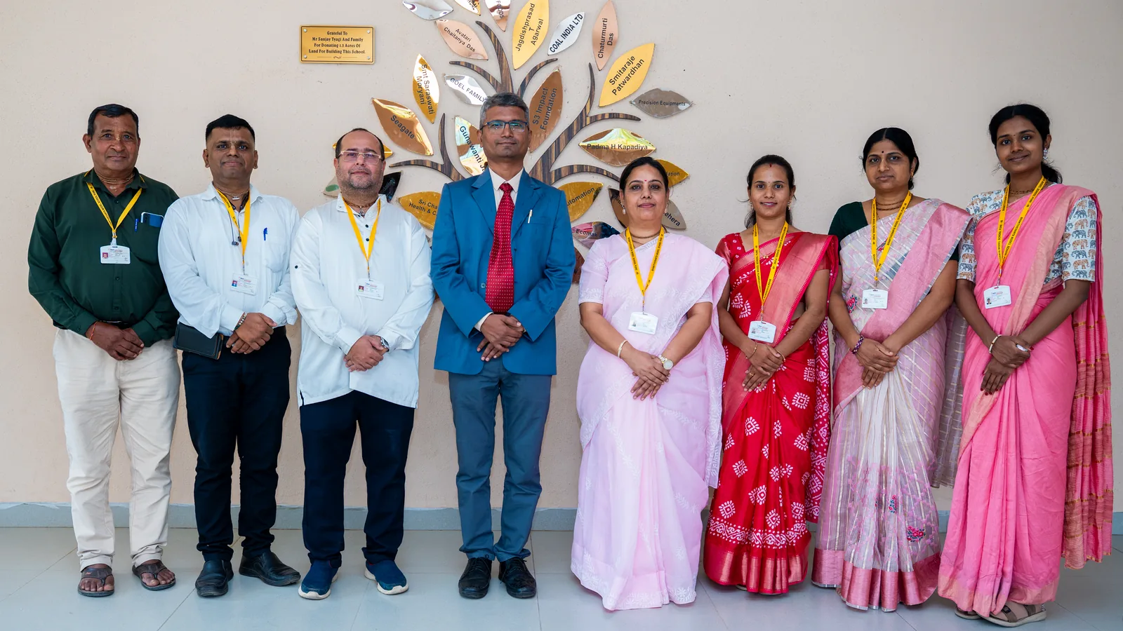 The school's teaching and administrative staff together in the foyer
